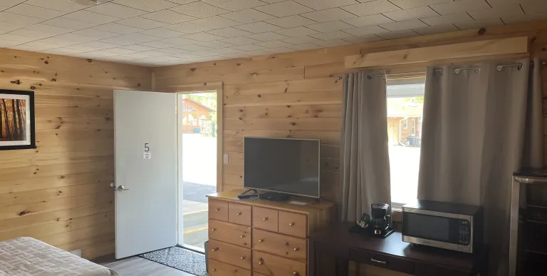 Facing the tv and window in a room.