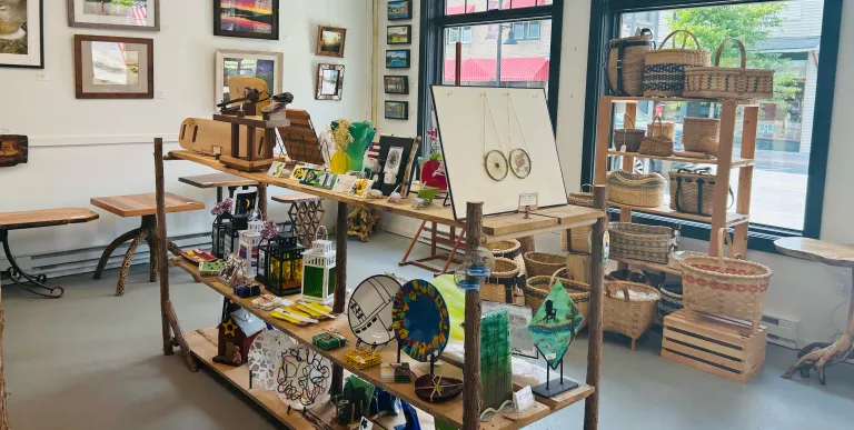 Various art medium on display shelves.