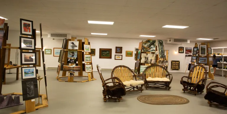 Man looks at art on display at the Tupper Arts Center