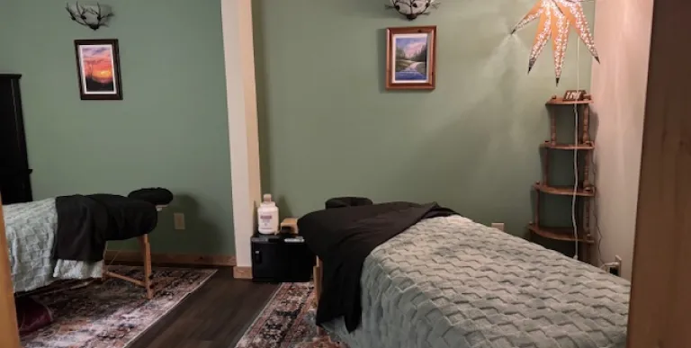 Treatment room with relaxing mint walls and soft lighting.