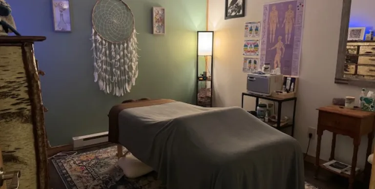 Treatment room with relaxing mint walls and soft lighting.