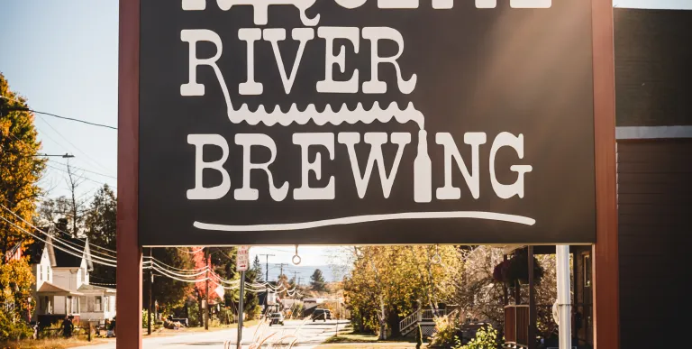 The sign by the road displaying the Raquette River Brewing logo