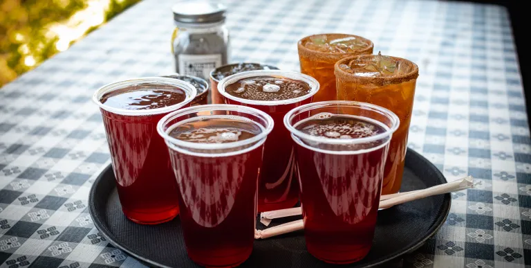A platter full of perfectly poured red ales on a table.