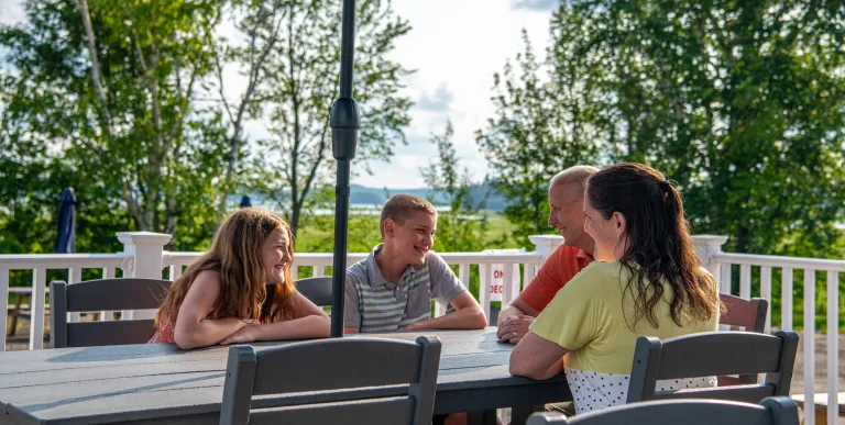 People sit around an outdoor table.