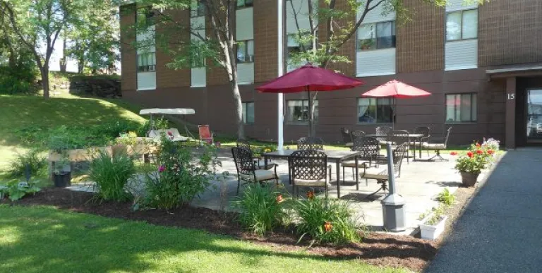 Patio area by grass at a brick complex