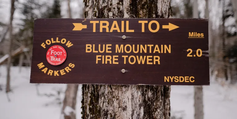 A wooden sign for Blue Mountain Fire Tower