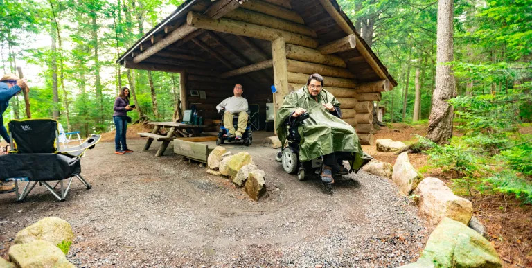 Two people at an accessible lean-to