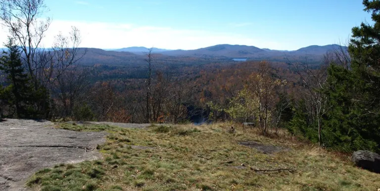 A hazy view of mountains from a summit