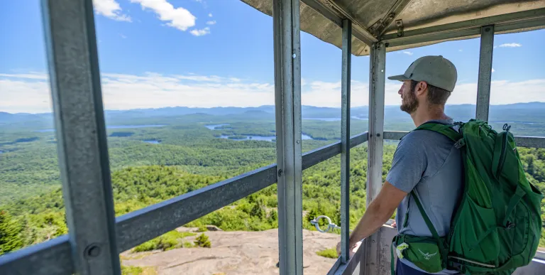 A hiker standing in the St Regis firetower