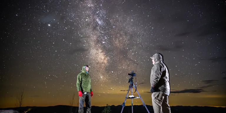 A couple people stargazing on Coney Mountain's bald summit