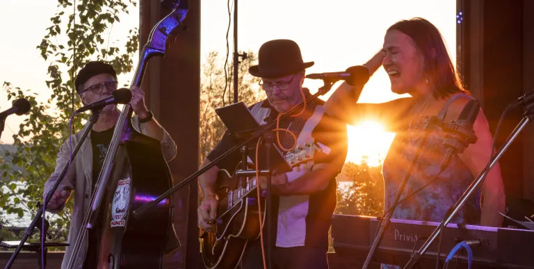 band sings as the sun sets at the bandshell in Tupper Lake