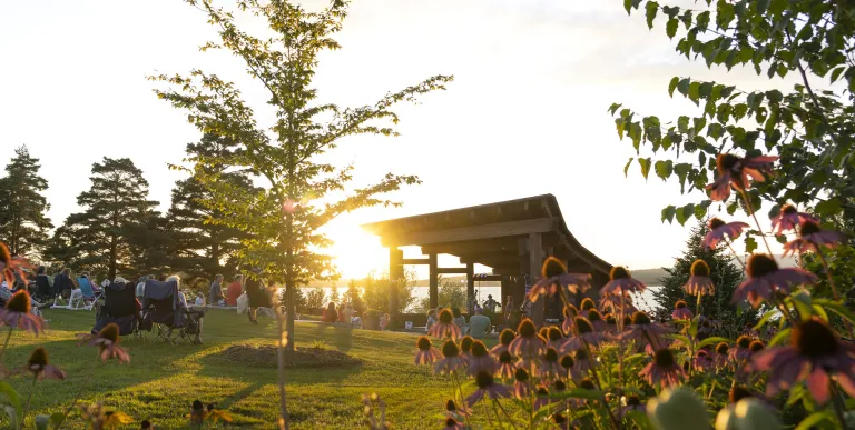 Crowd enjoys live music from the sunset stage bandshell as the sun sets