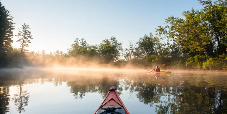 Kayakers in the early morning mist