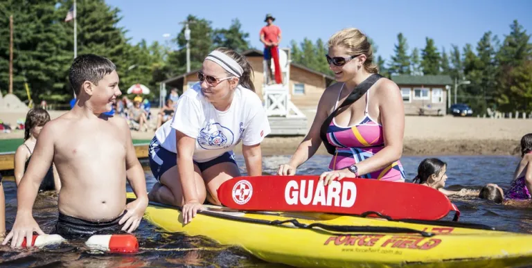 Someone jumps into the water from a floating dock