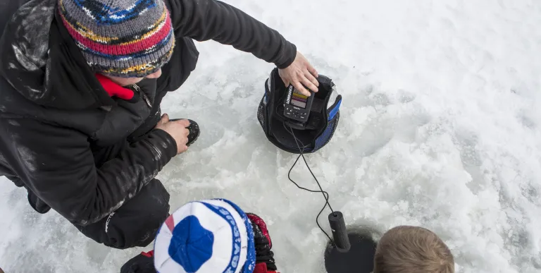 A family ice fishes