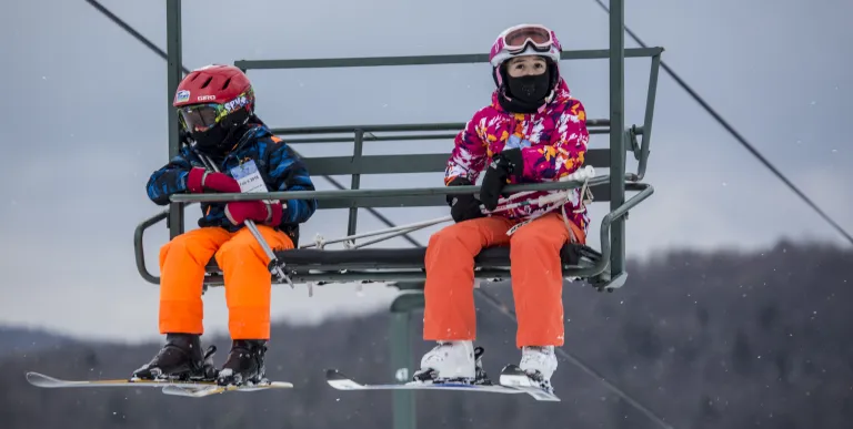 Two kids on a chair lift at Titus