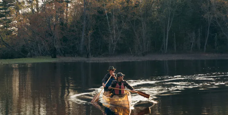 Two people in a pack canoe