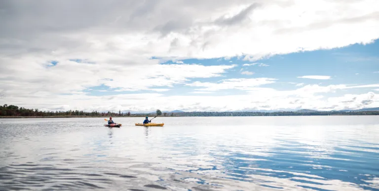 Two paddlers on a large pond