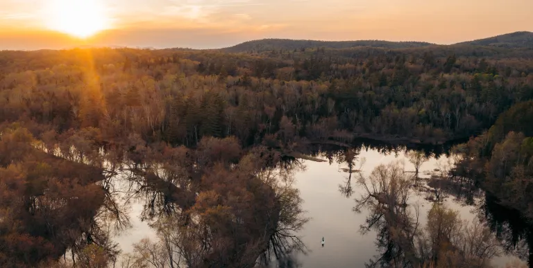 Aerial photo of a winding waterway at sunset