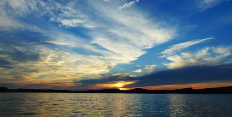 A sunset over a large lake