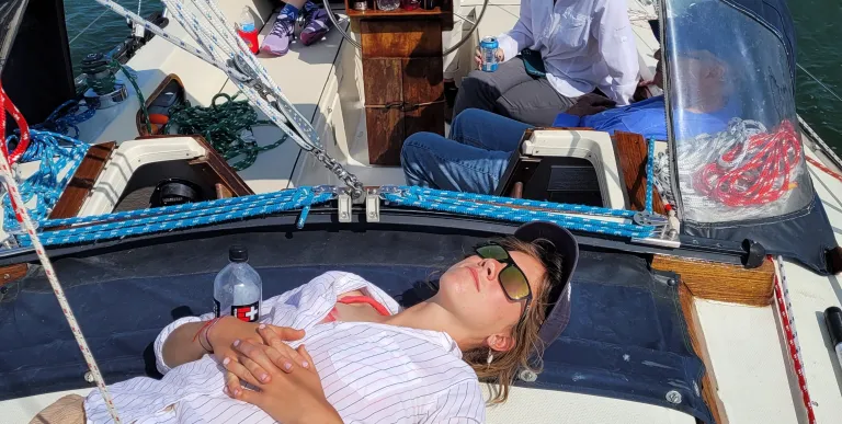 Person relaxing on sailboat