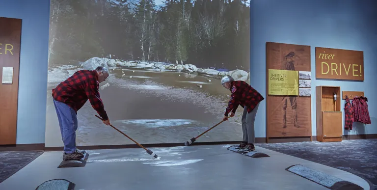 A fabric tent covering a raised deck next to the pond