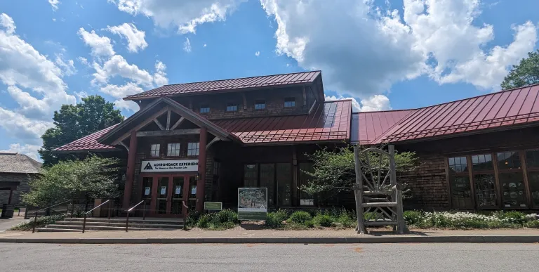  a blue carpet with a winding pathway design and blue light fixture that resembles waves