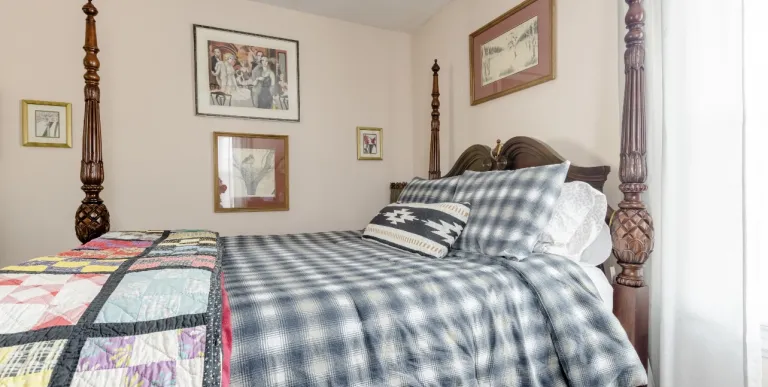 A guest room with a four post bed