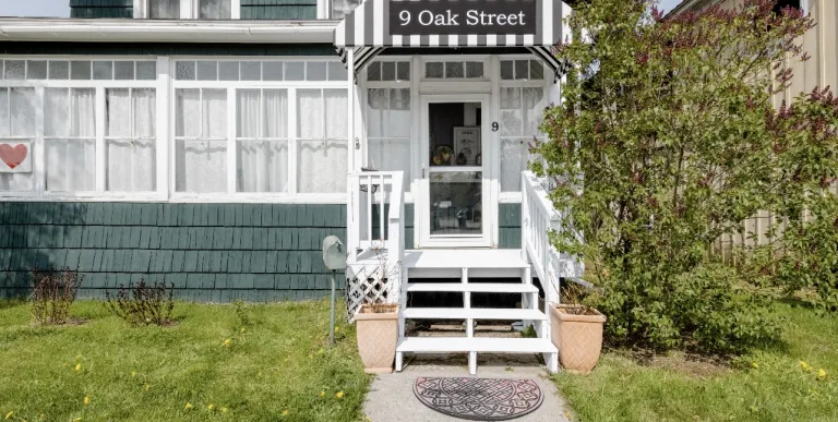 The formal dining space with comfy chairs and salmon walls