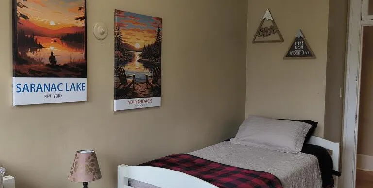 wooden headboard and a wooden arrow decor on the wall.
