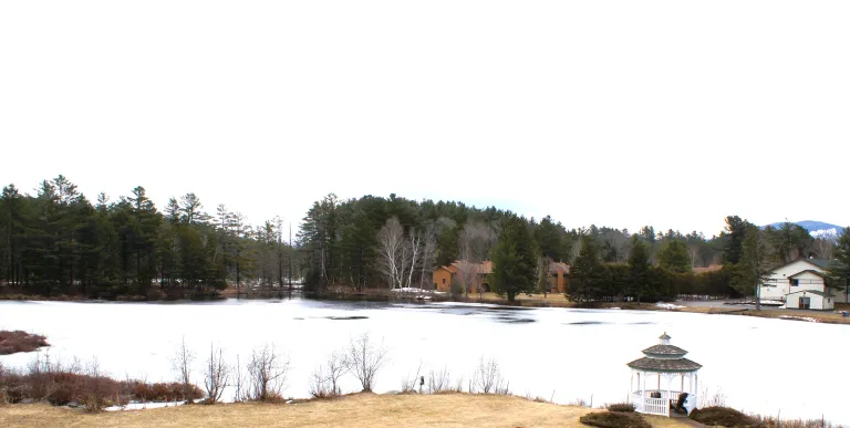 The snow covered pond by Sara Placid Inn & Suites.